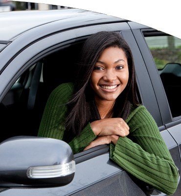 Young woman sitting in car looking out the window.